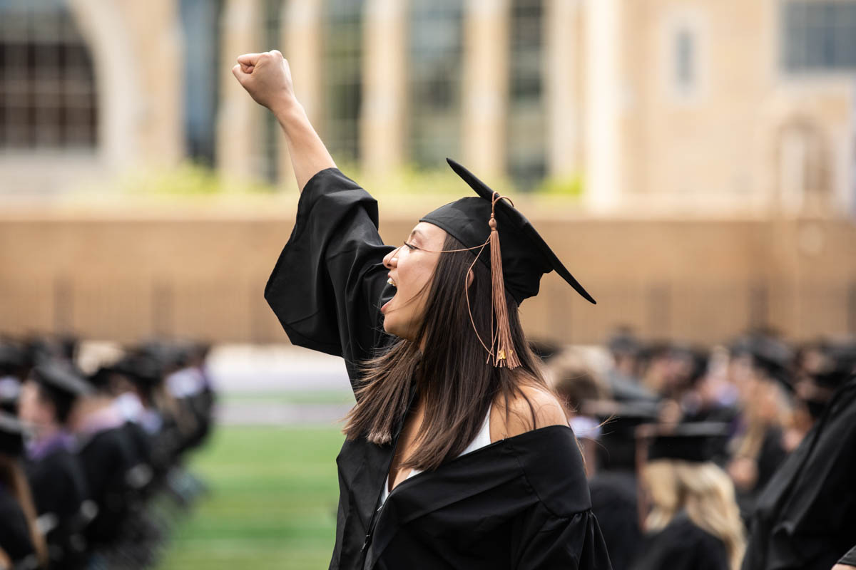 A student cheers during the 2022 Undergraduate Commencement Ceremony for the Opus College of Business on May 21, 2022, in St. Paul.