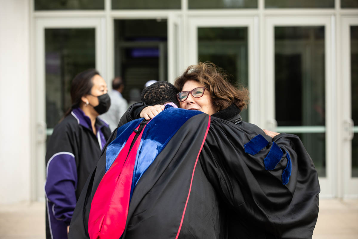 Mary Dougherty hugs DFC Dean Buffy Smith during the 2022 Undergraduate Commencement Ceremony for the Dougherty Family College on May 22, 2022, in St. Paul.