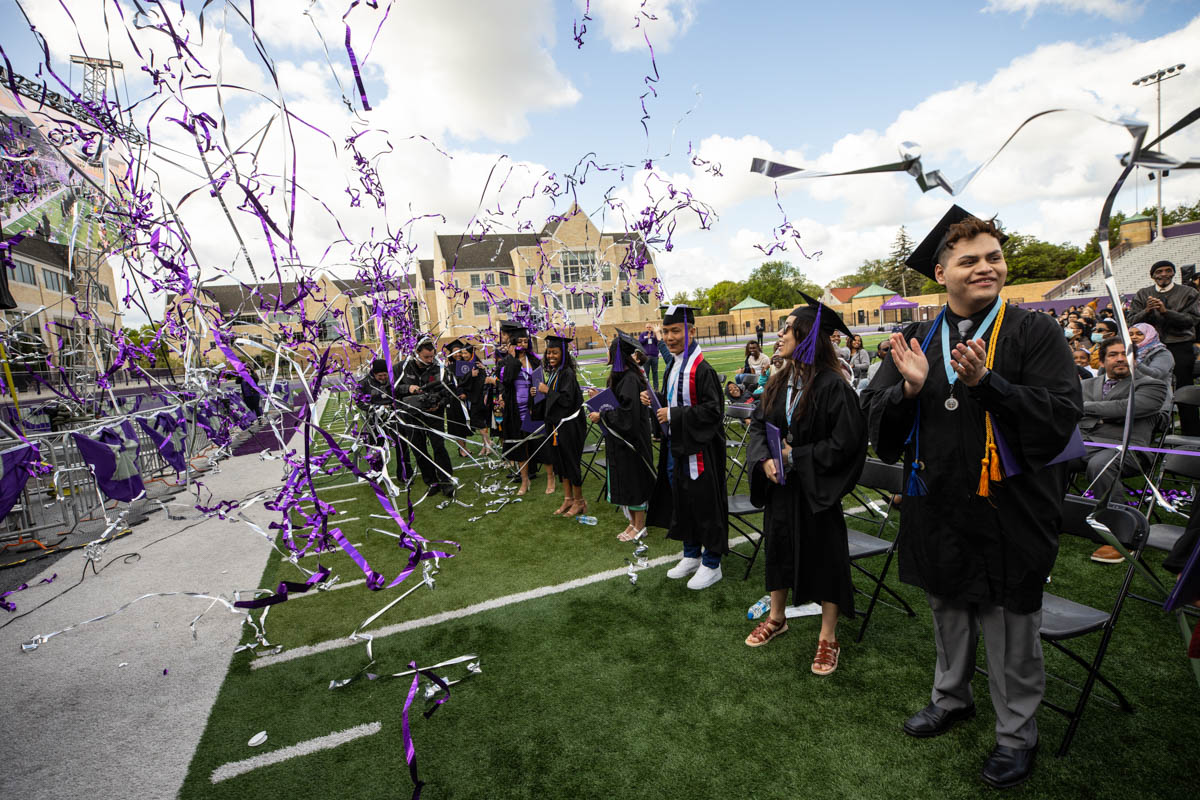 Graduates celebrate as confetti flies at the end of the 2022 Undergraduate Commencement Ceremony for the Dougherty Family College on May 22, 2022, in St. Paul.