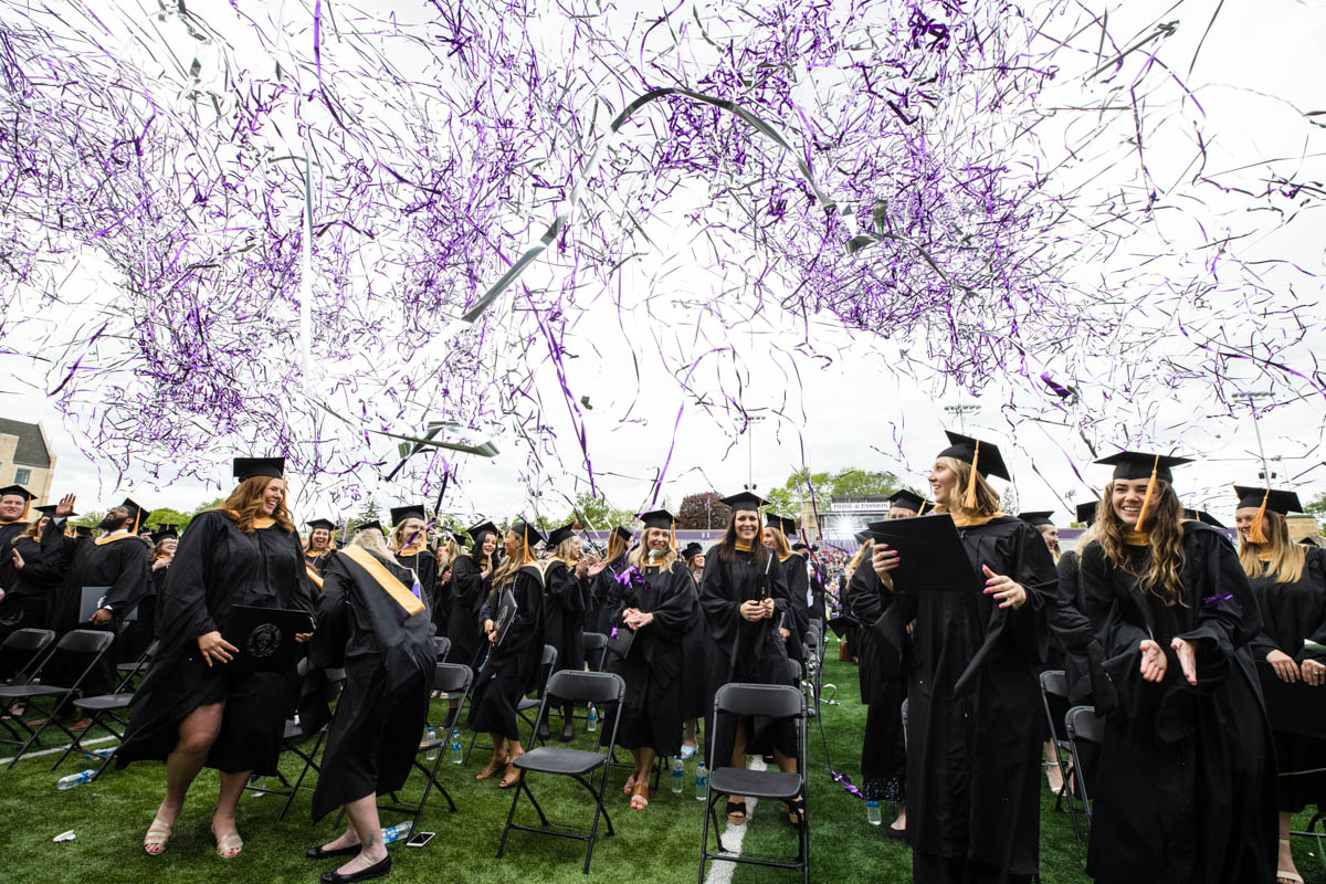 Confetti flies during the 2022 Graduate Commencement ceremony for the College of Arts and Sciences, the Morrison Family College of Health and the School of Engineering in St. Paul on May 22, 2022.