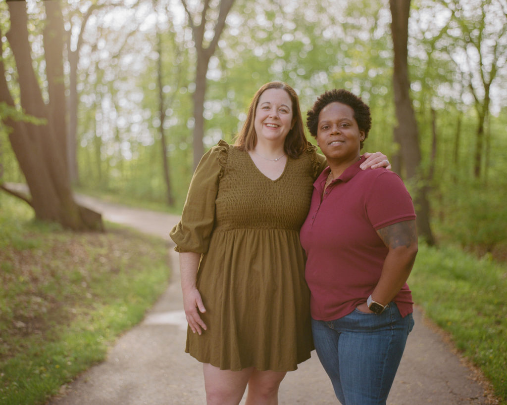 Patricia Maddox, left, Assistant Professor of Sociology in the Department of Justice and Society Studies poses for a portrait with her wife Shantel at a park near their home on May 19, 2022, in Plymouth.