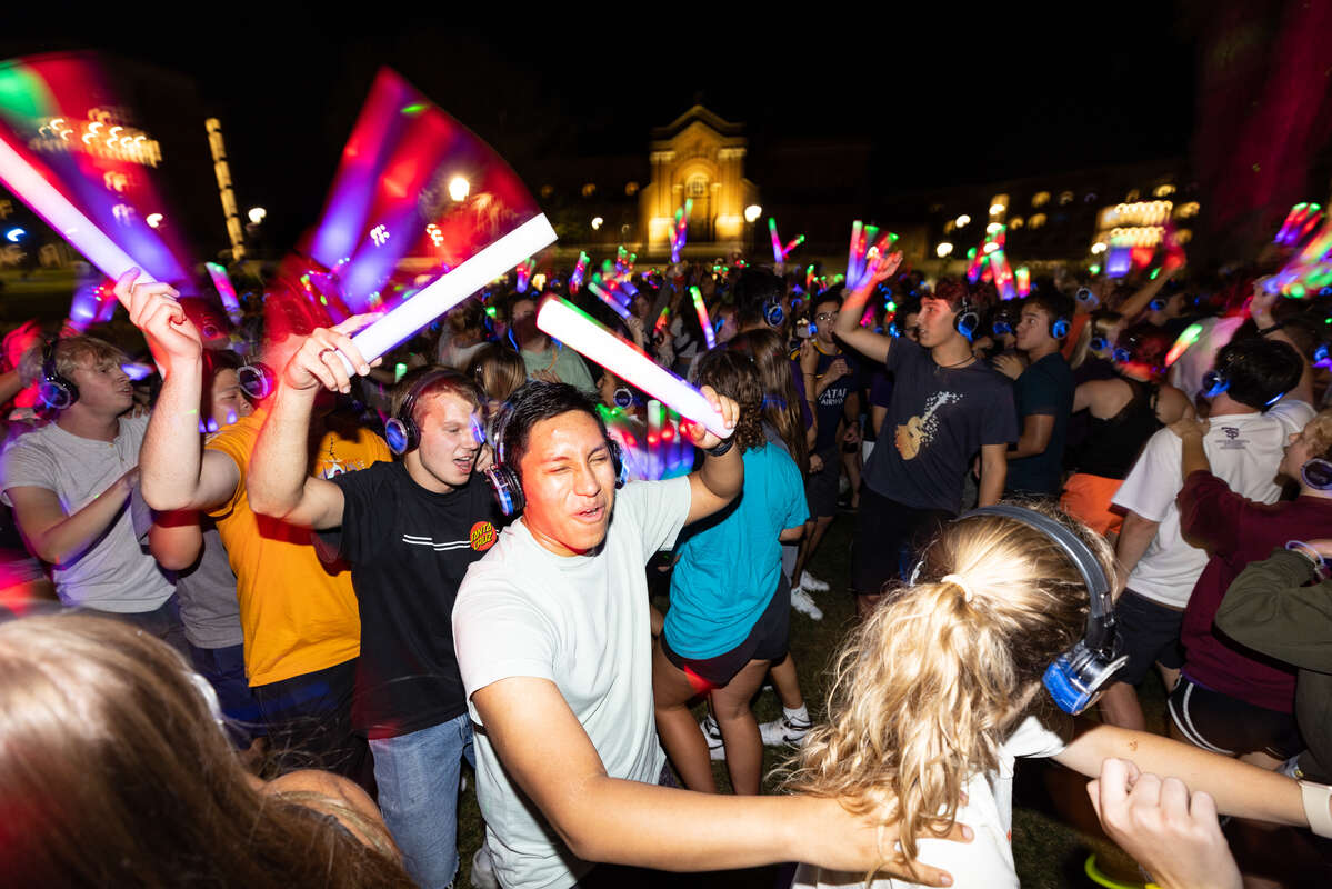 Students dance and celebrate during Headphone Disco on the upper quad. Mark Brown/University of St. Thomas
