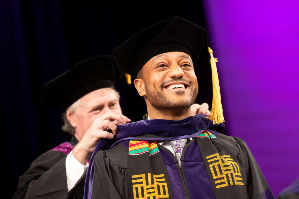 A graduate smiles during the 2022 School of Law Commencement ceremony at the Minneapolis Convention. Mark Brown/University of St. Thomas