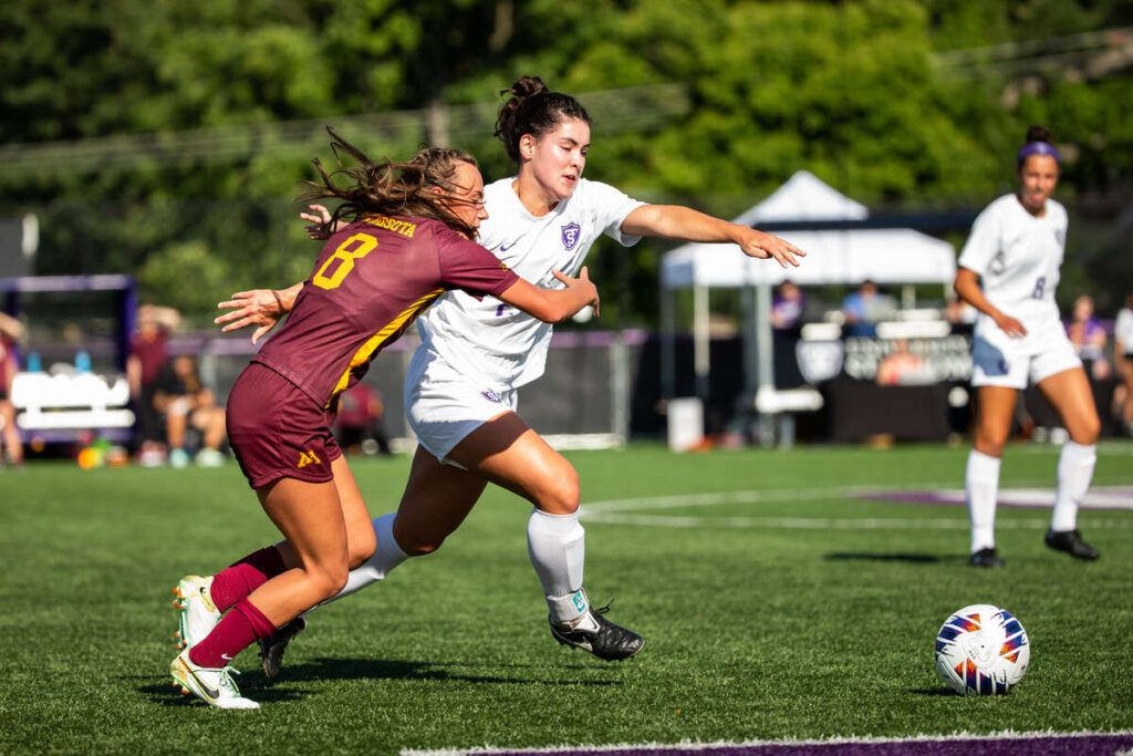 Ellie Tempero fights for the ball during an exhibition game between the women’s soccer team and the University of Minnesota. Mark Brown/University of St. Thomas