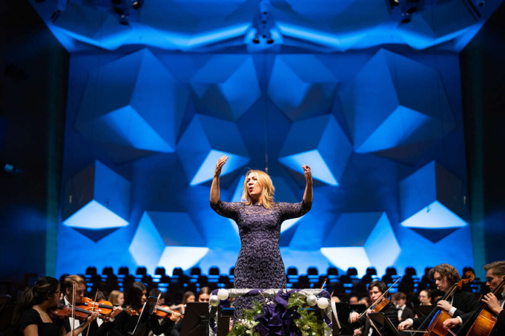Professor Angela Mitchell conducts singers during A St. Thomas Christmas: Dawning Light, at Orchestra Hall. Mark Brown/University of St. Thomas