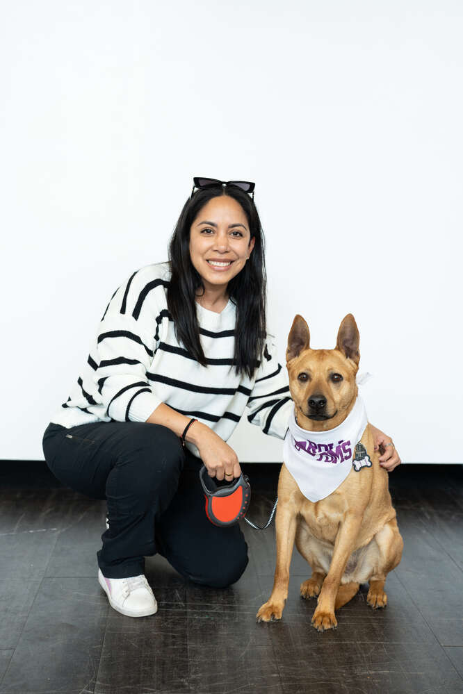 Members of the University of St. Thomas community pose for photos with their pets for National Pet Day in the create[space]. Mark Brown/University of St. Thomas