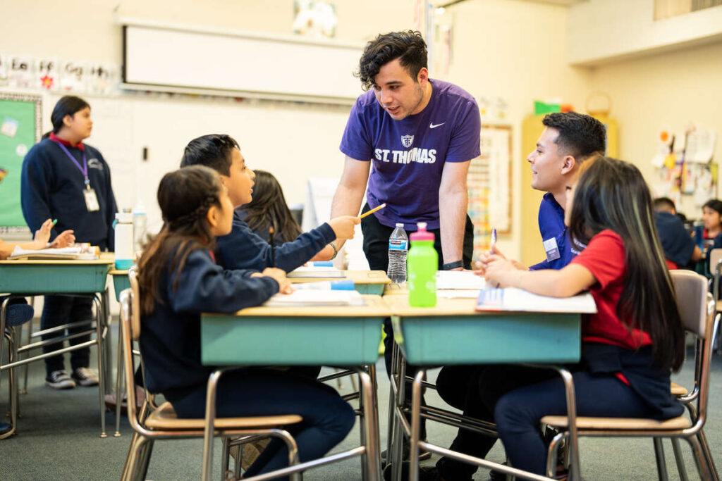 University of St. Thomas and Dougherty Family College students volunteer in a 5th grade class at Christ is Risen Catholic School in South Minneapolis. Mark Brown/University of St. Thomas
