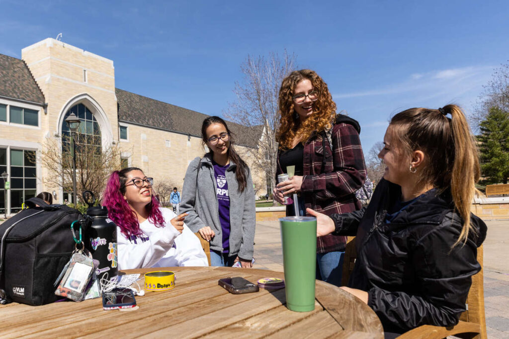 Students enjoy a sunny spring day on the St. Paul campus on April 18, 2023. Mark Brown/University of St. Thomas