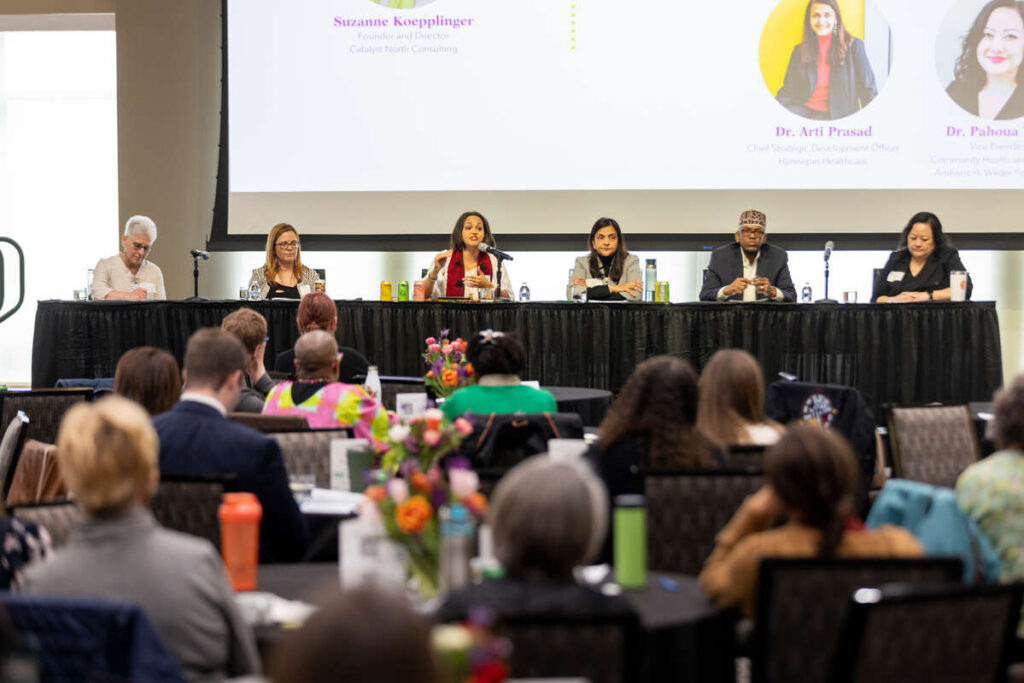 Panel members speaking at the Whole Person Health Summit in Woulfe Alumni Hall on April 19, 2023, in St. Paul. Brandon Woller/University of St. Thomas