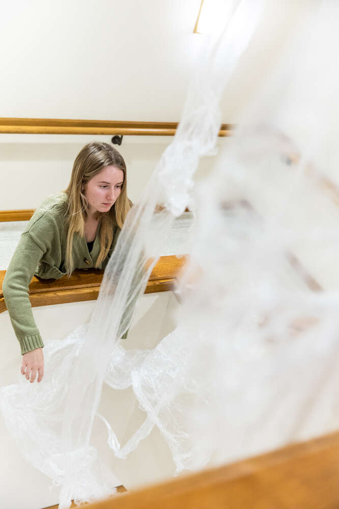 Students work on the assembly of the “Water Under Our Feet” art installation in the O’Shaughnessy-Frey Library in St. Paul on April 19, 2023. Mark Brown/University of St. Thomas
