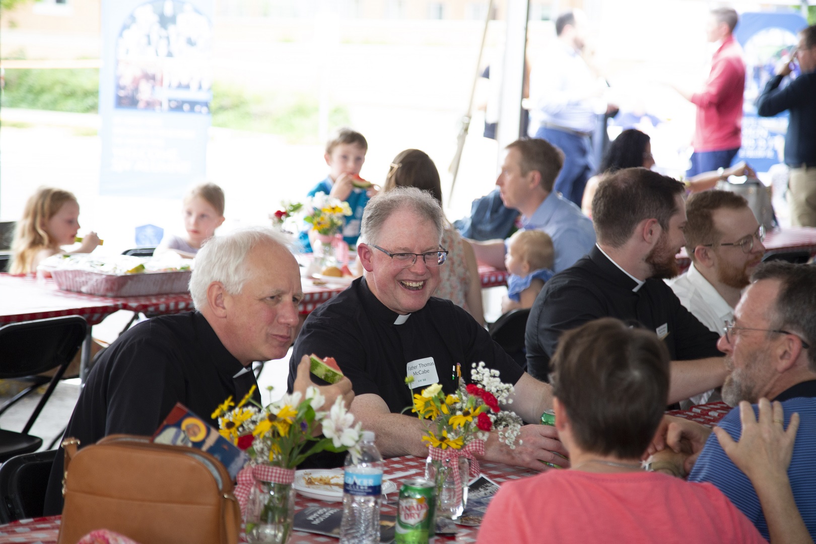 Father John Gerritts and Father Thomas McCabe eating.