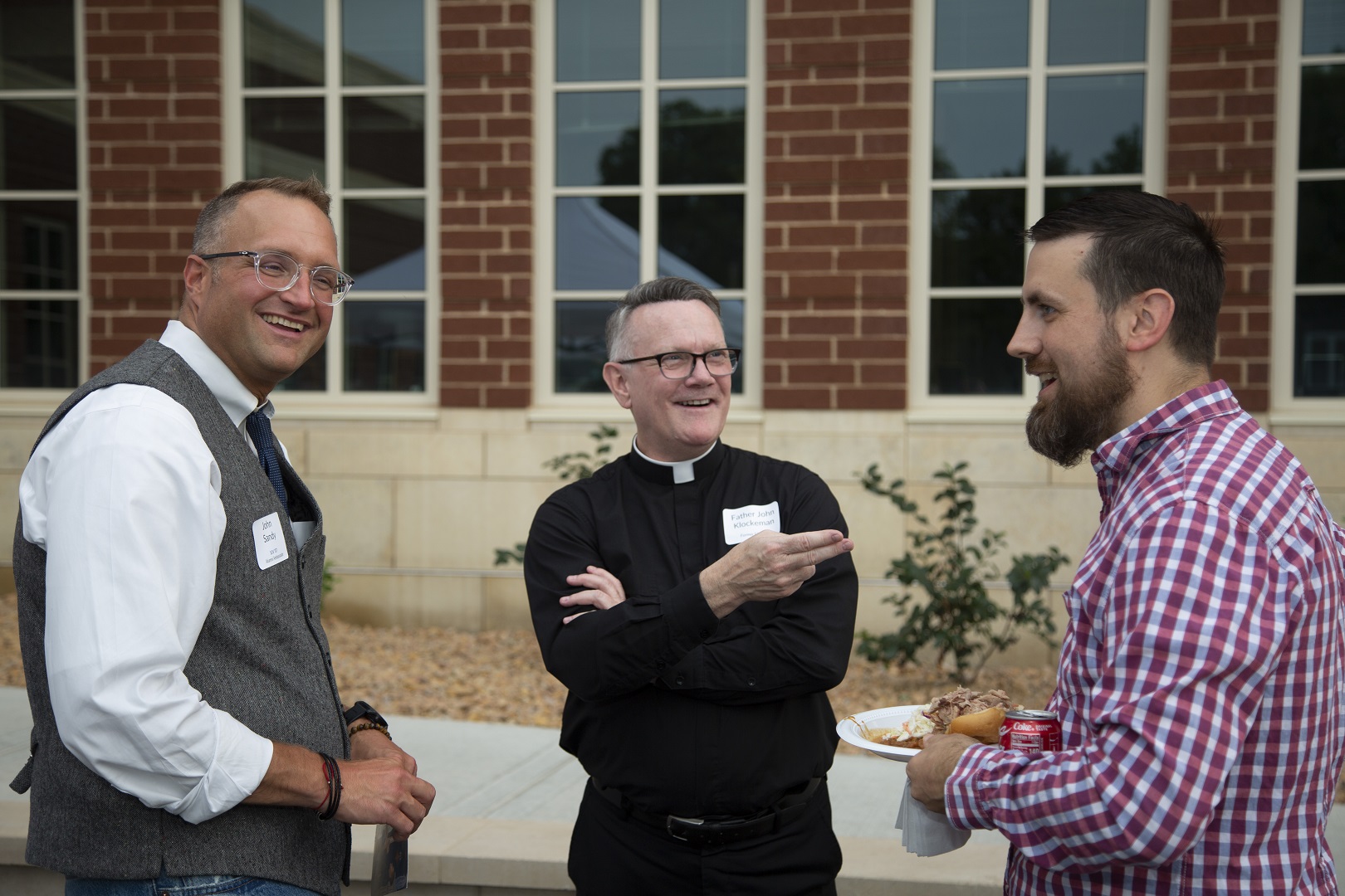 John Sandy, Father John Klockeman and Jeremy Irlbeck talk.