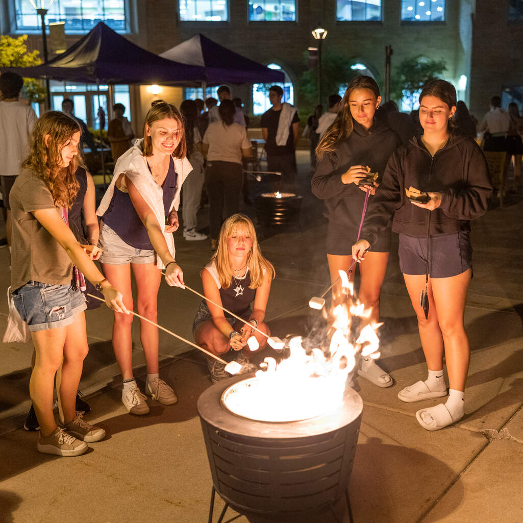Students around a bonfire.