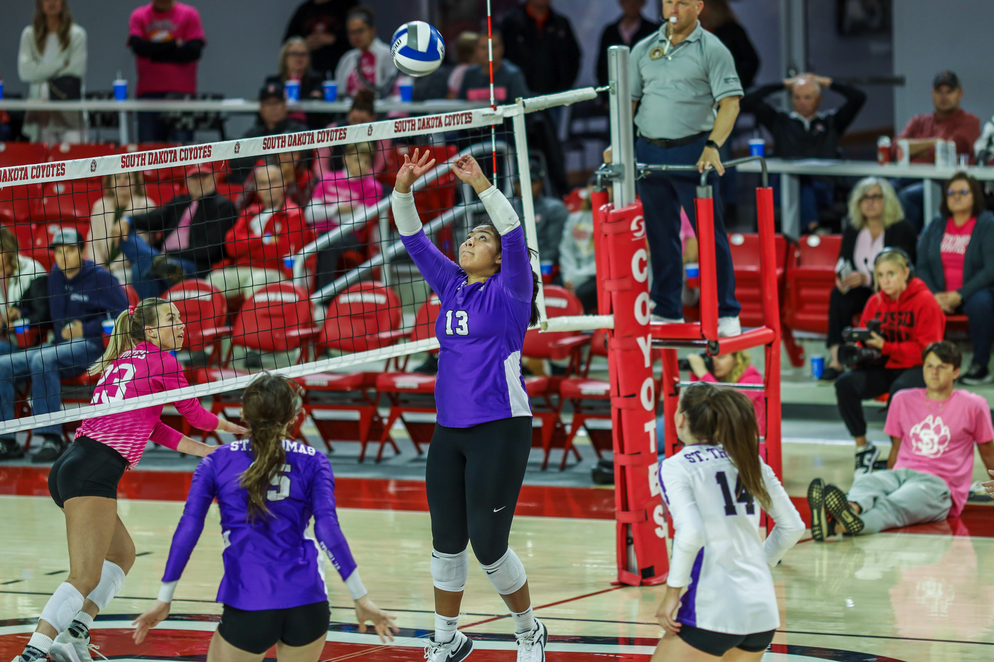Keya Luta Win Hunt sets up a shot for her teams on the St. Thomas Volleyball Team in a match against the South Dakota Coyotes.