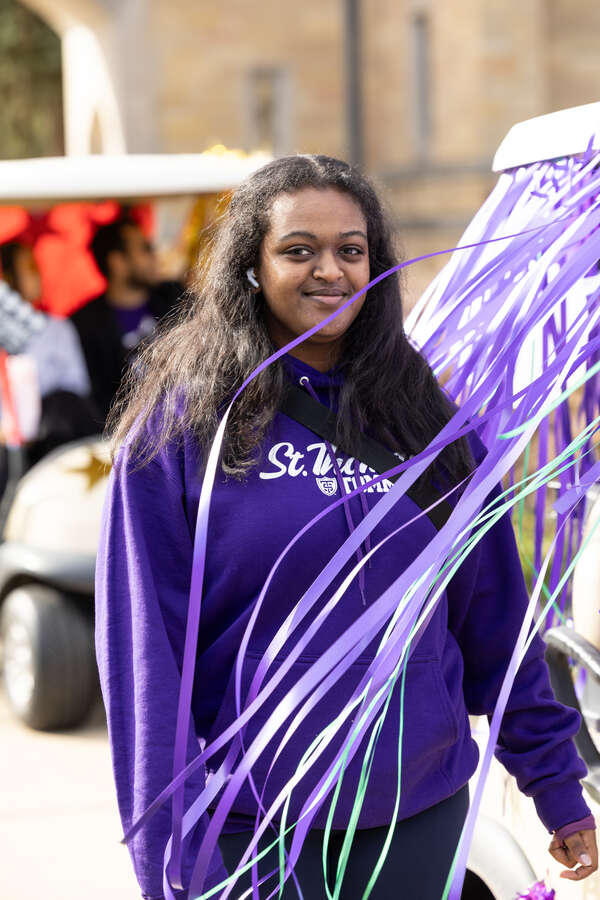 A student smiling during the golf cart parade.