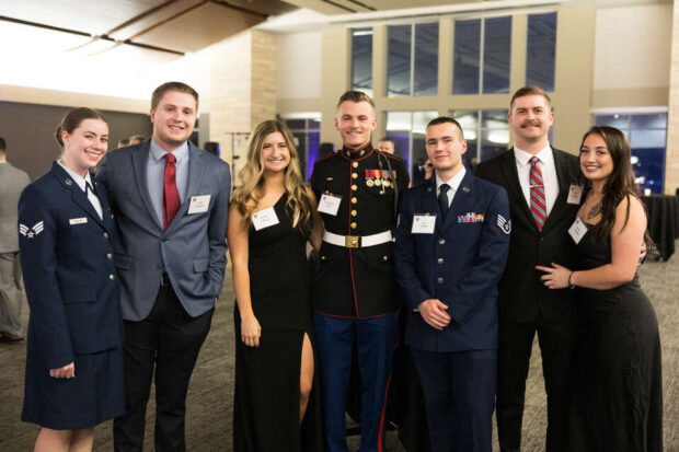 Attendees pose for a photo at the Fifth Annual Veteran’s Ball in Woulfe Alumni Hall on November 10, 2023, in St. Paul.