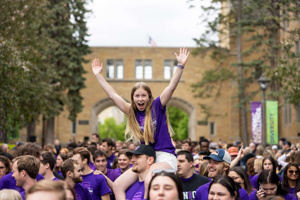 Students marching through the arches at the March out of the Arches event celebrating graduating seniors on May 19, 2023, in St. Paul.
