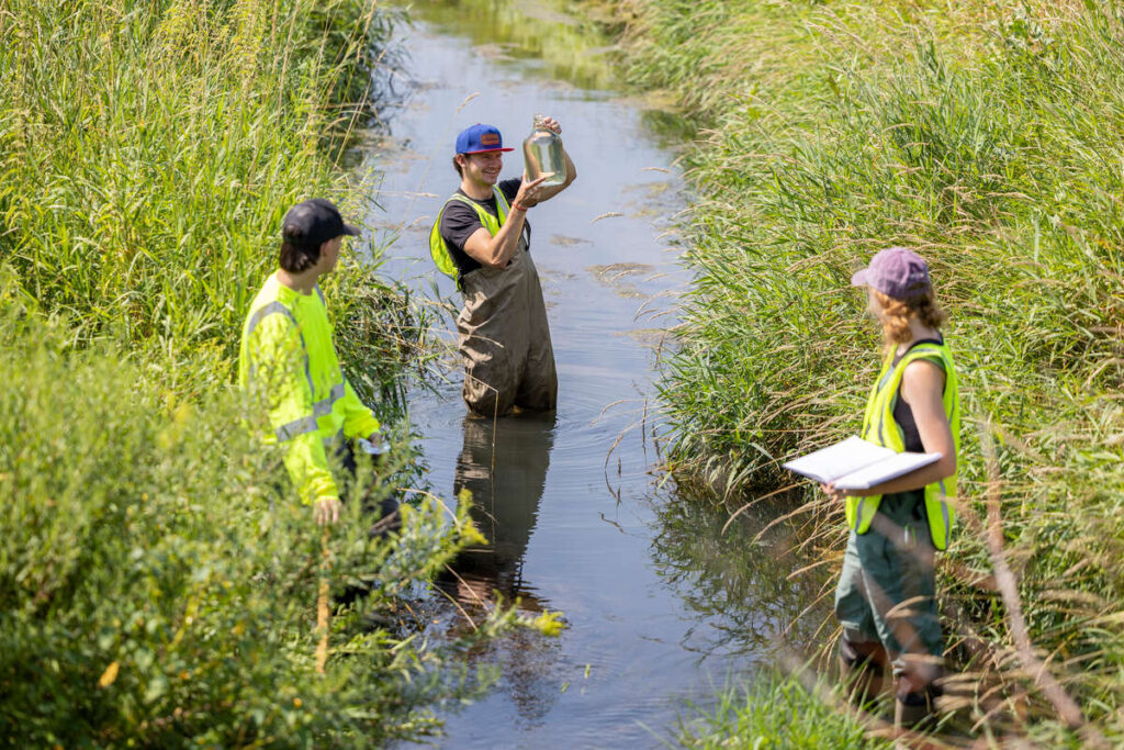 Students from the University of St. Thomas Wammer Lab conduct chemistry field research near a wastewater treatment facility in Litchfield, Minnesota on August 7, 2023.
