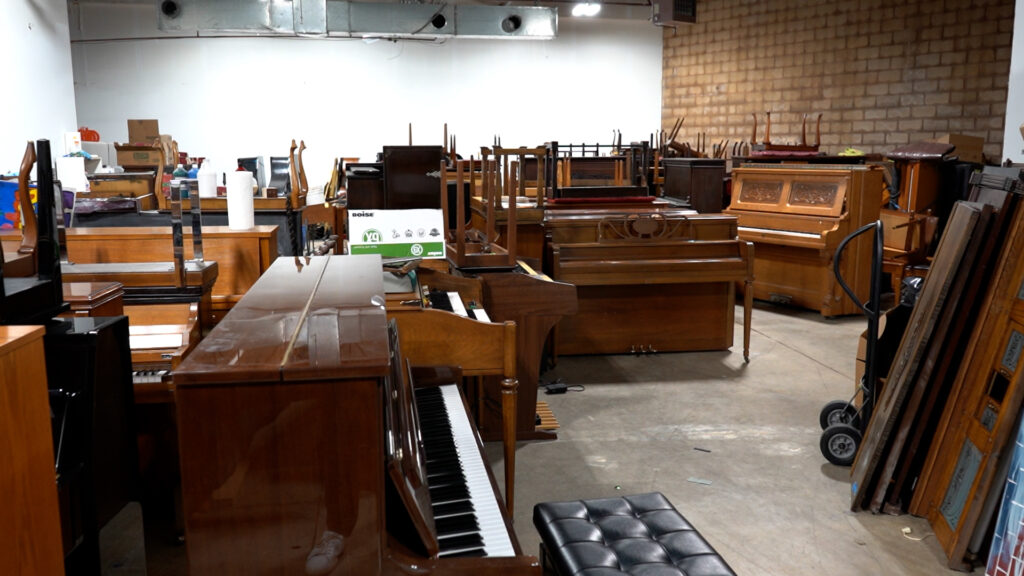 The Keys 4/4 Kids stock room is full of donated pianos.