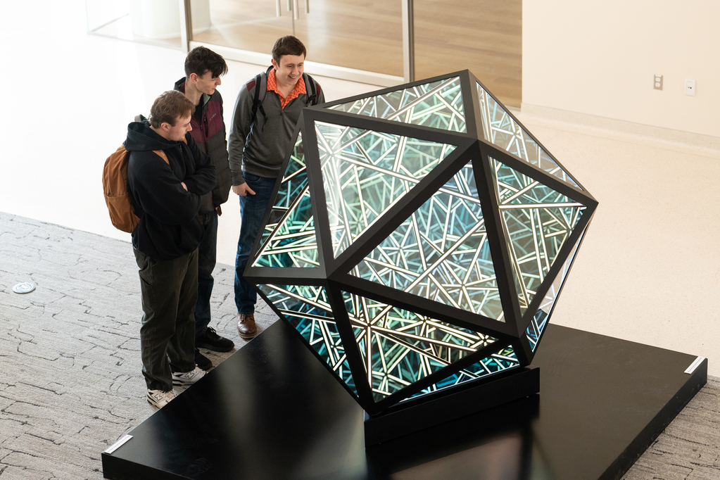 Students check on the Anthony James Icosahedron sculpture on the first day of spring semester in Schoenecker Center on February 5, 2024, in St. Paul.