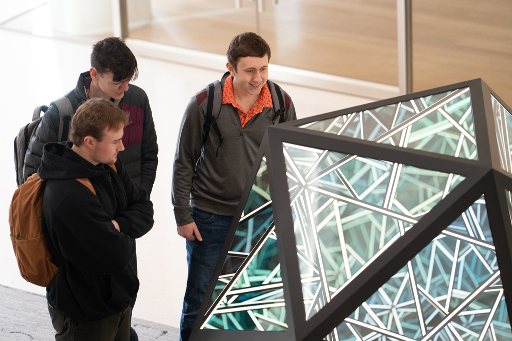 Students check on the Anthony James Portal Icosahedron sculpture on the first day of spring semester in Schoenecker Center on February 5, 2024, in St. Paul.