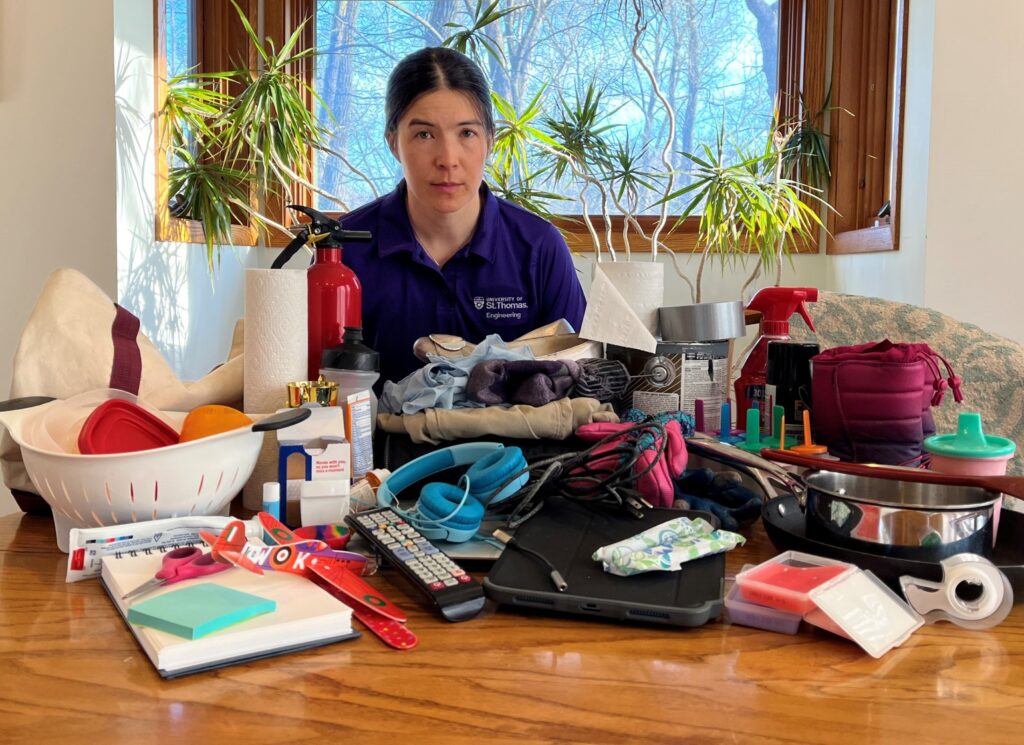Professor Ali Ling surrounded by items containing PFAS chemicals