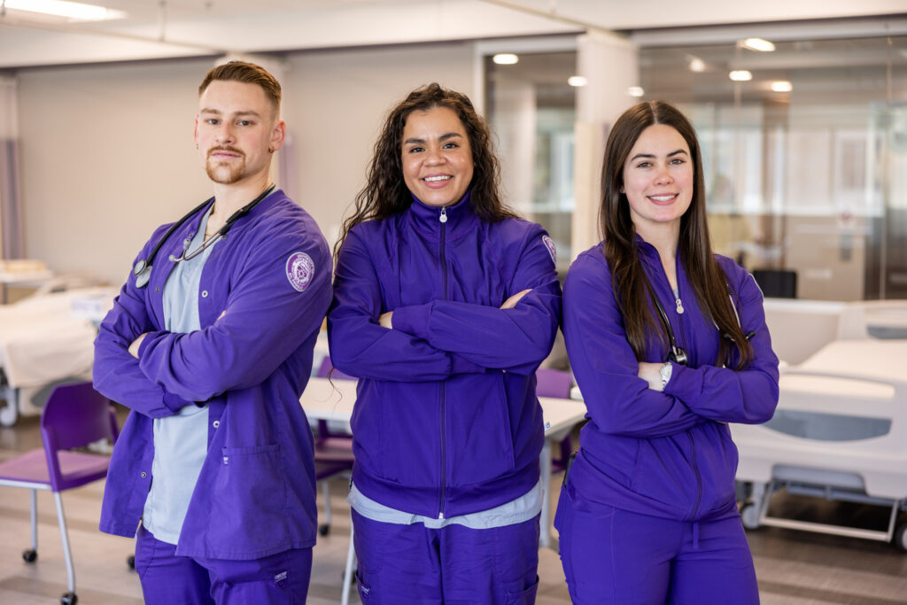 Roy Palmer, Nuela Cannady, and Emily Pieper pose for a photo in the School of Nursing's Center for Simulation.