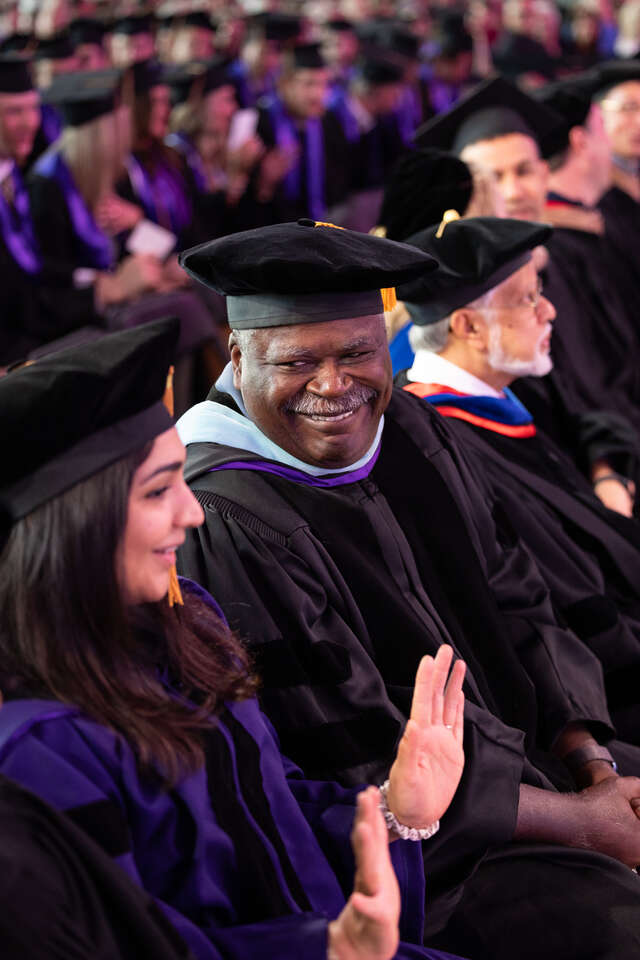 Professor Ernest Owens during the 2024 Opus College of Business Undergraduate Commencement Ceremony in the Field House in St. Paul on May 25, 2024.