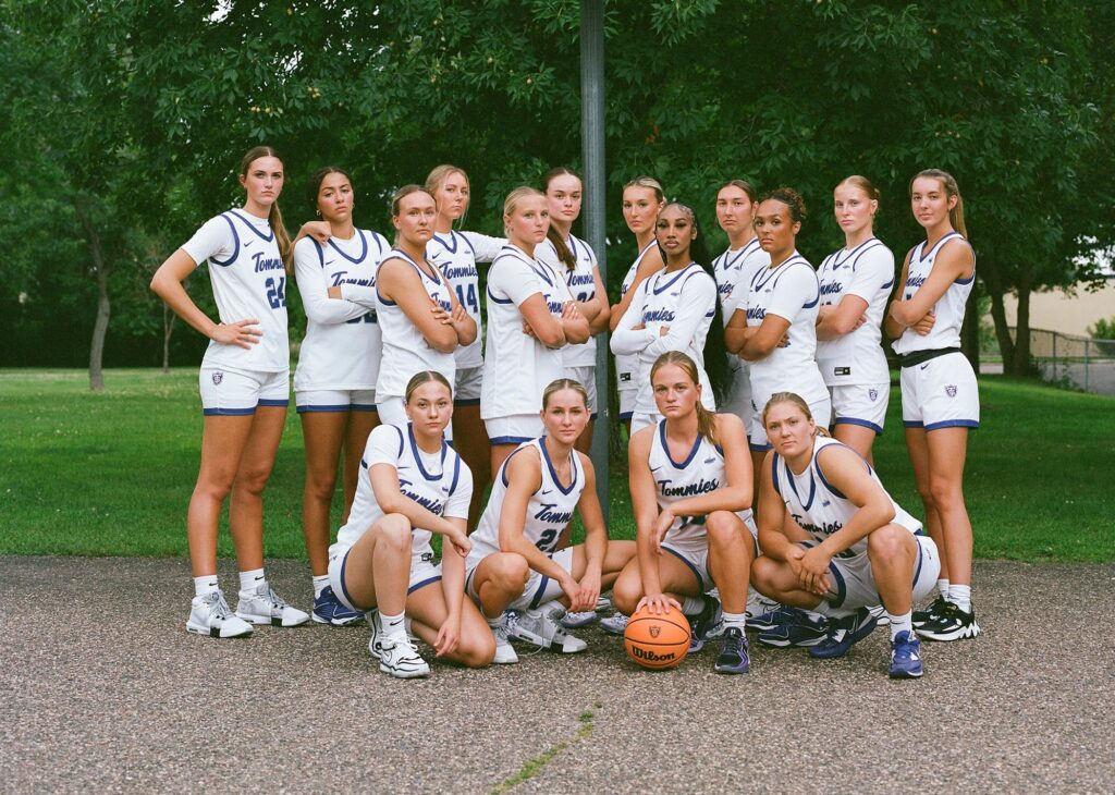 Members of the University of St. Thomas women’s basketball photographed on medium format film behind the scenes during a promo video shoot on July 23, 2024, in Aldine Park in St. Paul.