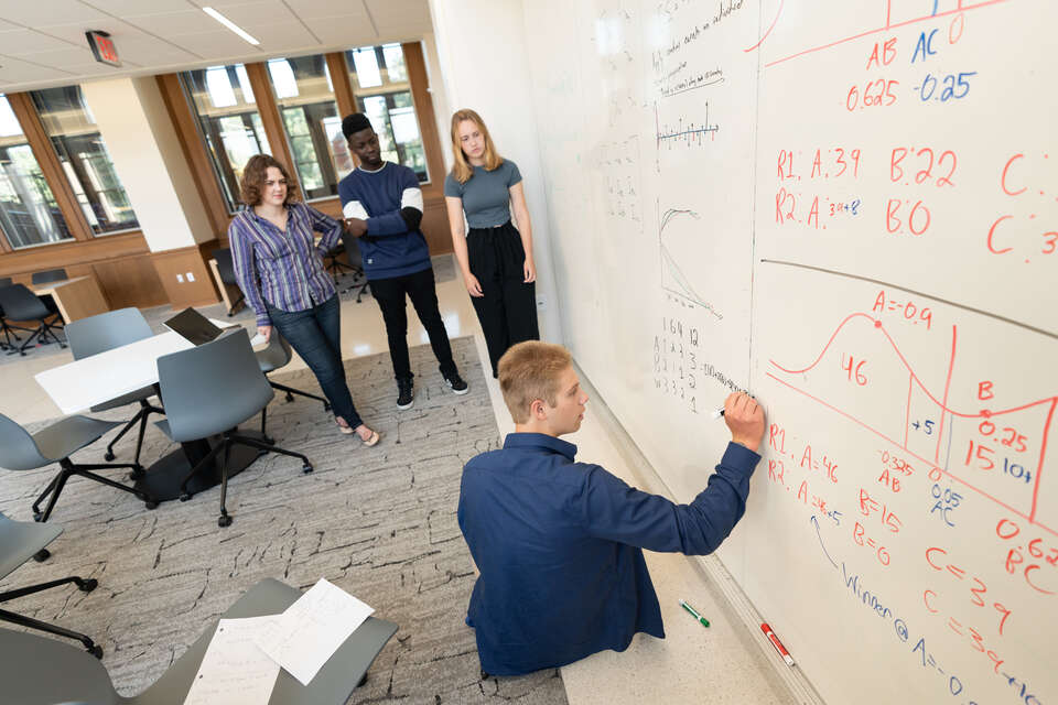 Students in Mathematics Professor Natasa Dragovic summer research class work on a research project focused on political campaigns in Schoenecker Center on August 7, 2024, in St. Paul.