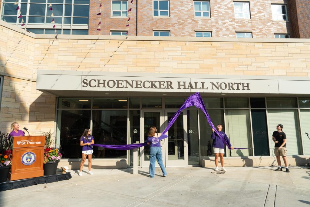 Students, staff, faculty and the St. Thomas Board of Trustees gather to announce a state record-setting gift for scholarships, along with the renaming of Tommie North Residence Hall. The gift came from the Schoeneckers Foundation, a nonprofit established in the name of alum and longtime donor Guy Schoenecker and his wife Barbara. Tommie North Residence Hall was renamed to Schoenecker Hall North. The event took place on the St. Paul campus on September 19, 2024.