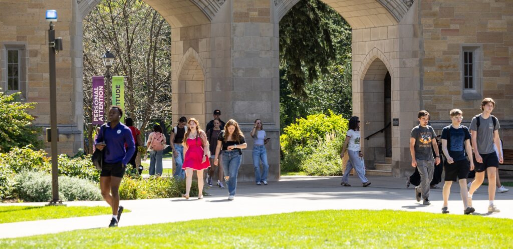 Students walk in front of the Arches.