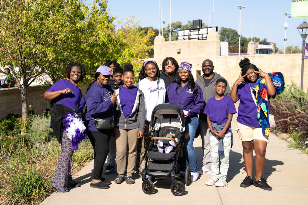 Football player and family pose for a photo.