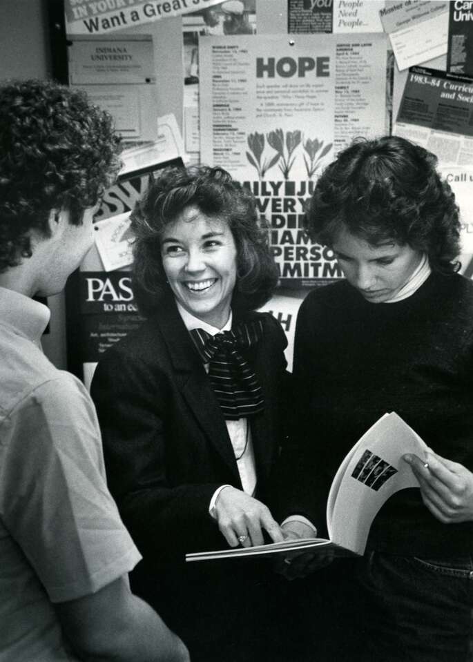 Barbara Shank (c) with students. Scanned from original print, scanned on December 8, 2008.  "07.24.03 Shank, Barbara", "Barbara Shank Social work dept." and stamped "St. Thomas College Audio-Visual Department File #C83-130B" on verso.