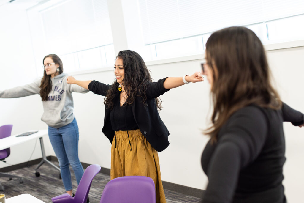 Students in Professor Alicia Powers’ Social Work Masters class work on stretches and crafts during a class session on March 15, 2023, in St. Paul in the Summit Classroom Building.