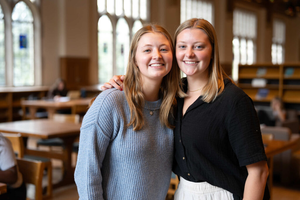 Lizzy Rusch (Elementary Education) left, and sister Lauren Rusch (Marketing) right, photographed at the OSF Library on October 3, 2024, in St. Paul.