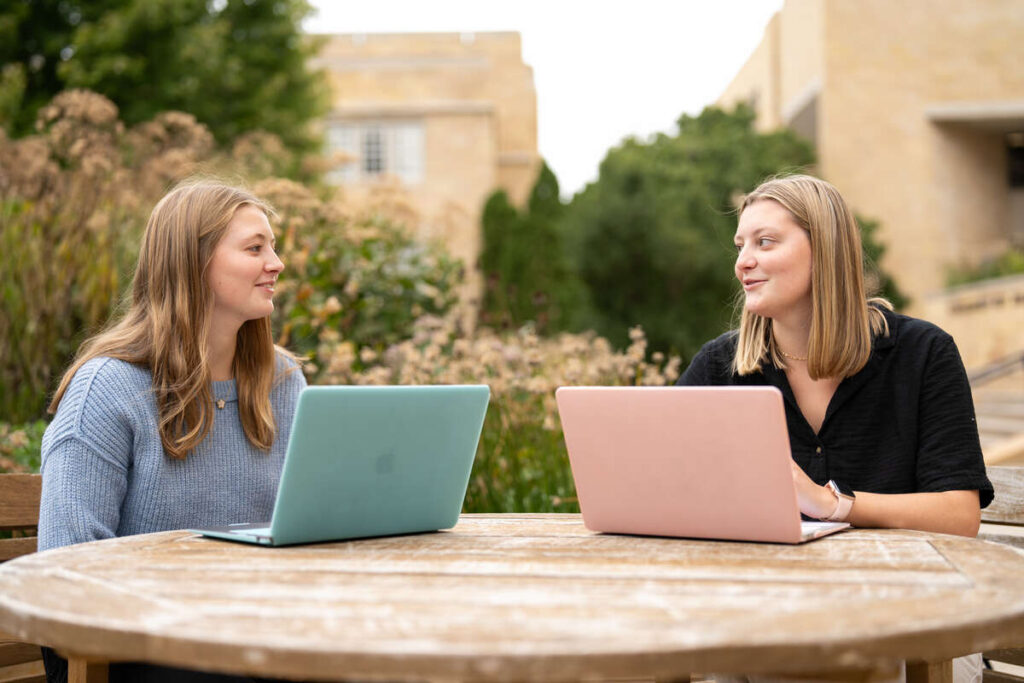 Lizzy Rusch (Elementary Education) left, and sister Lauren Rusch (Marketing) right, photographed at the OSF Library on October 3, 2024, in St. Paul.