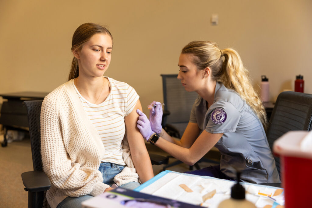 Nursing student administers flu shot at the Center for Well-Being