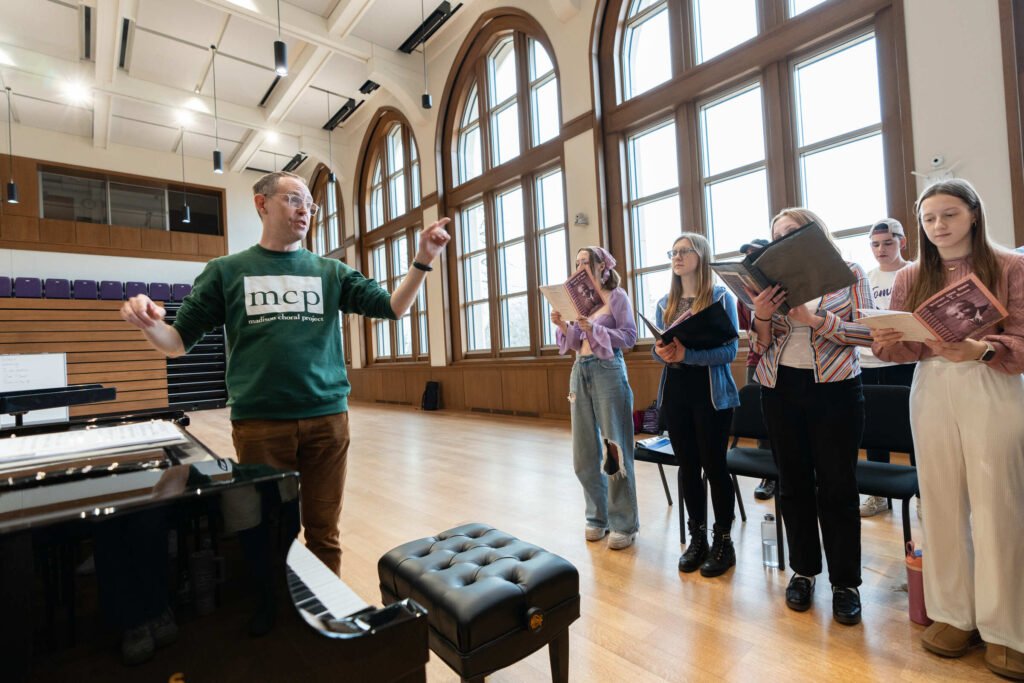 Music Professor Bert Pinsonneault leading a choir practice.