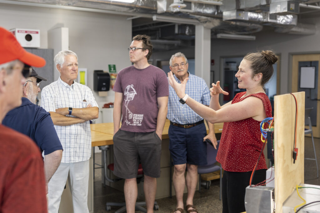 Ophelia Loree, Microgrid Research Engineer, presents during the MN EVO group’s tour of the UST Center for Microgrid Research on June 5, 2023, on the Anderson Parking Facility on St. Paul Campus.