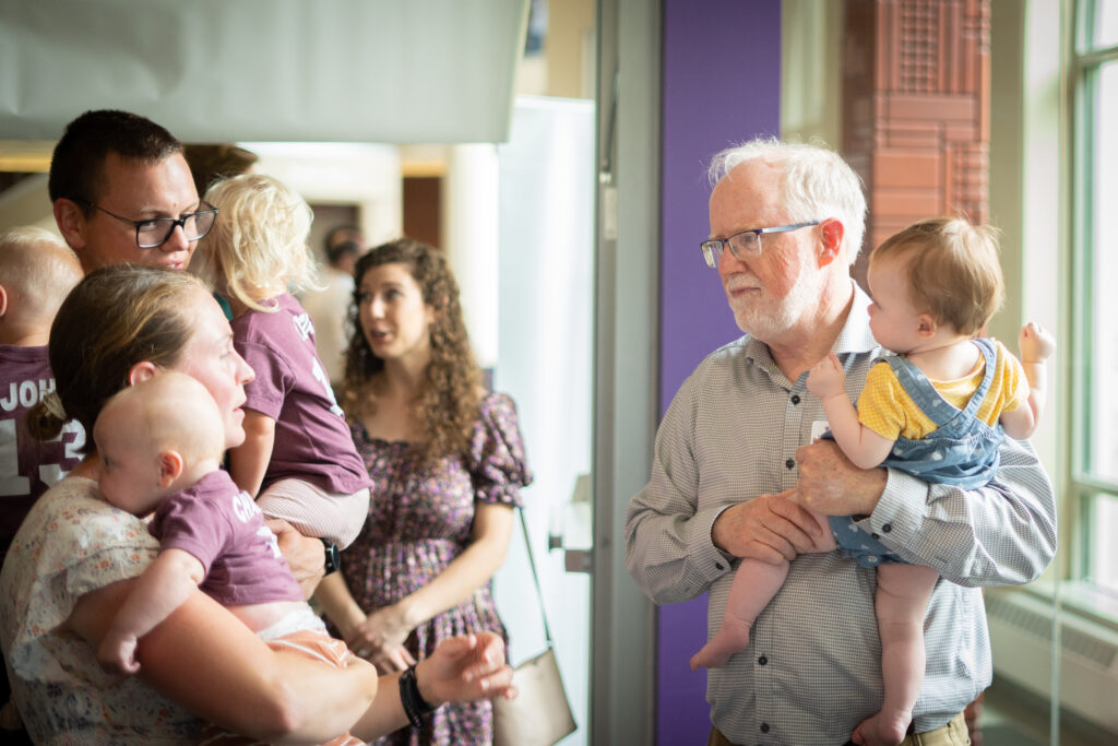 Group of adults holding babies. 