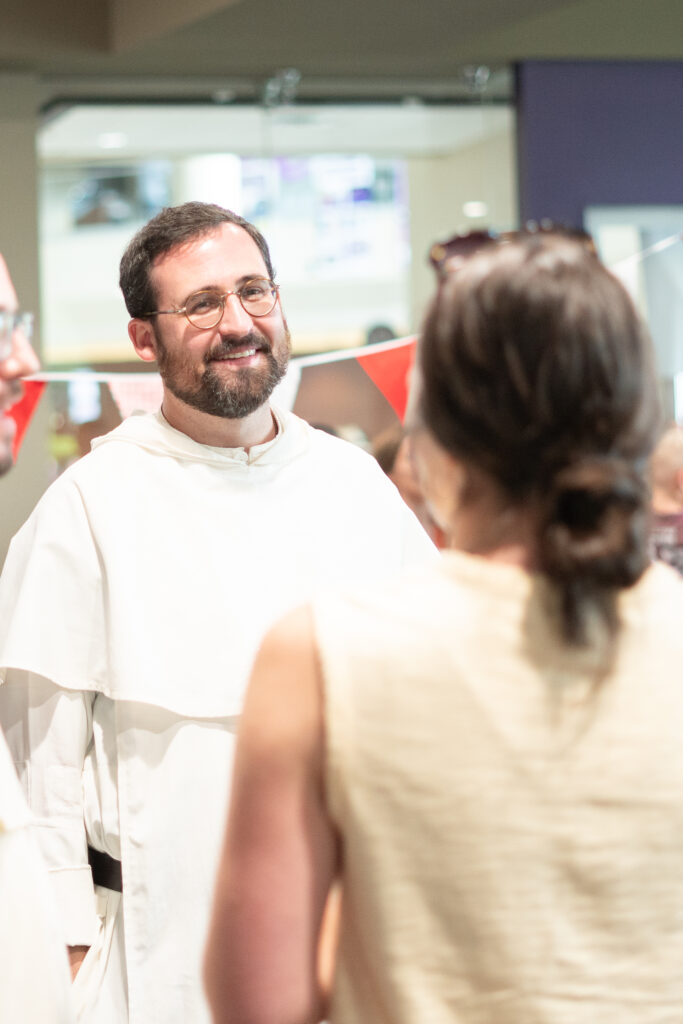 A Dominican friar talking to a woman.  