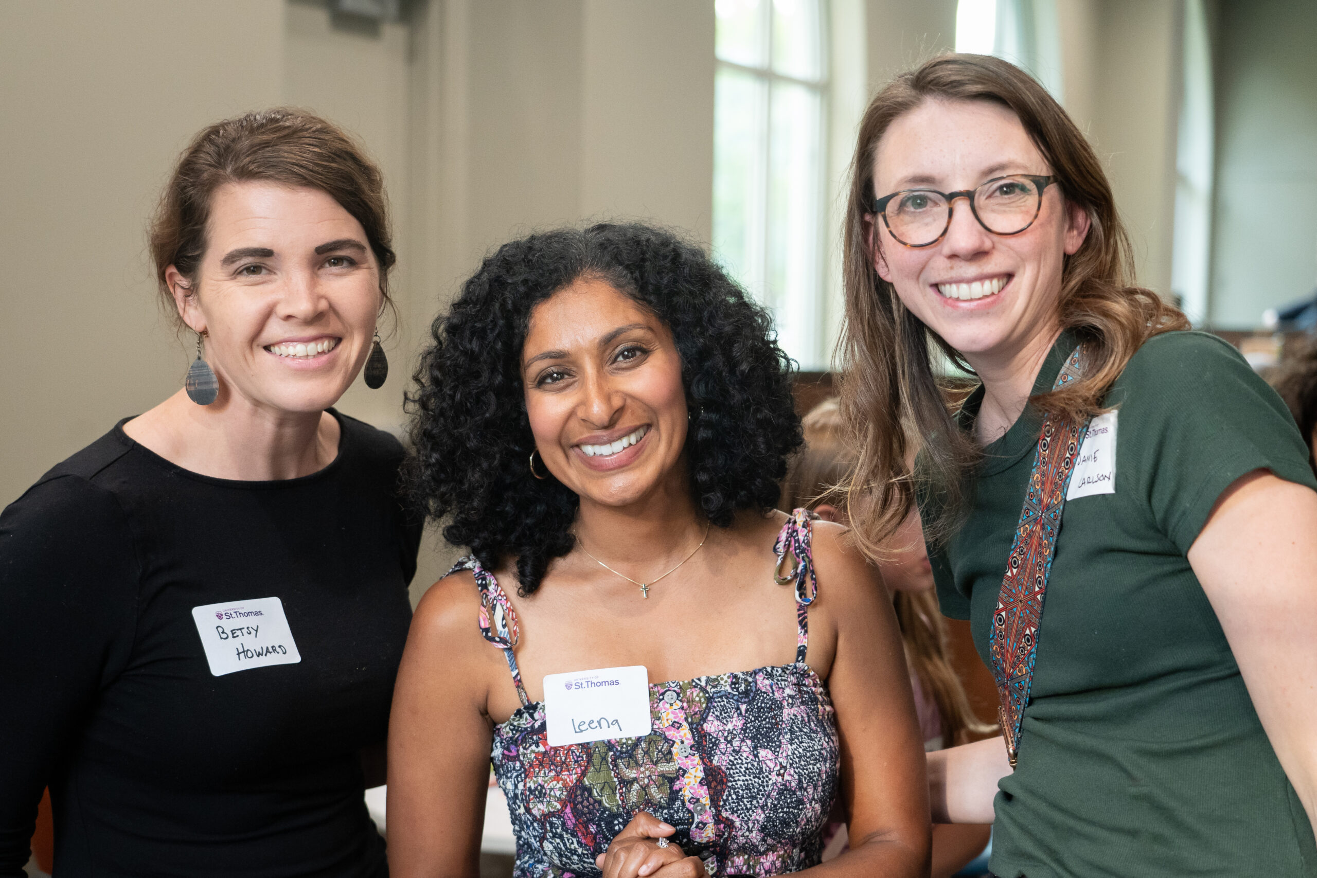 Three women smiling.