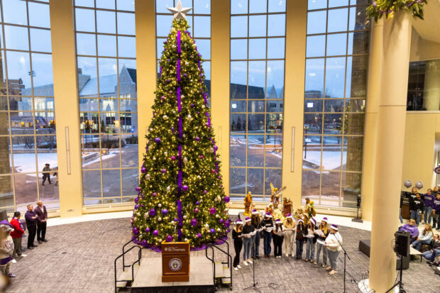 Cadenza performing in front of Christmas tree.