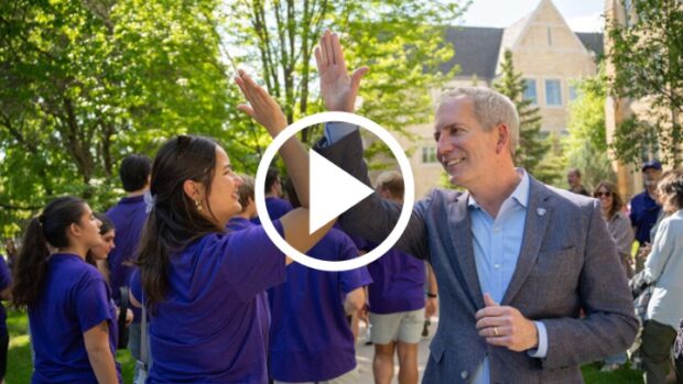 President Rob Vischer gives a student a high five during March out of the Arches on May 23, 2025, in St. Paul.