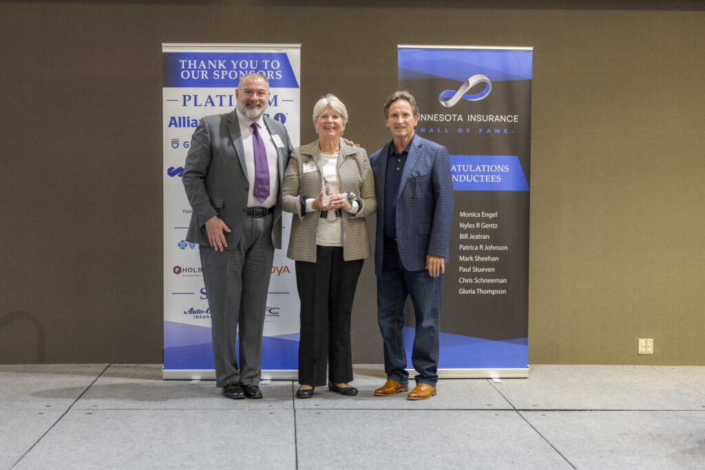 Patricia R. Johnson posing with Dan Riley and Bill Ryan