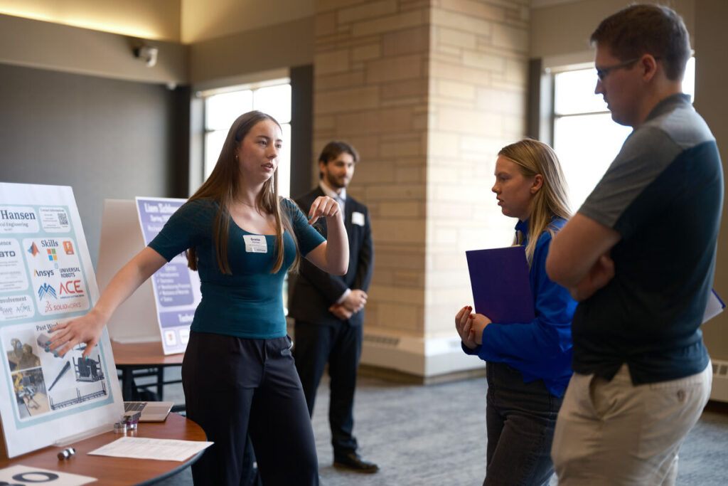 Greta Hansen speaks with two recruiters