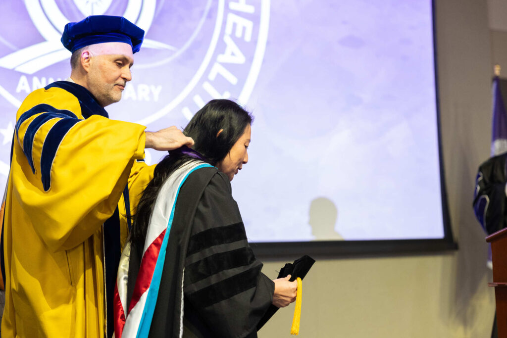 Dean MayKao Hang Investiture and Morrison Family College of Health receives medal from Provost Eddy Rojas