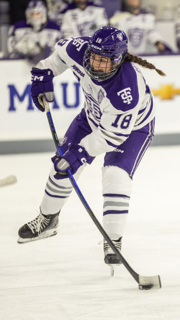 Ellah Hause skating with the puck