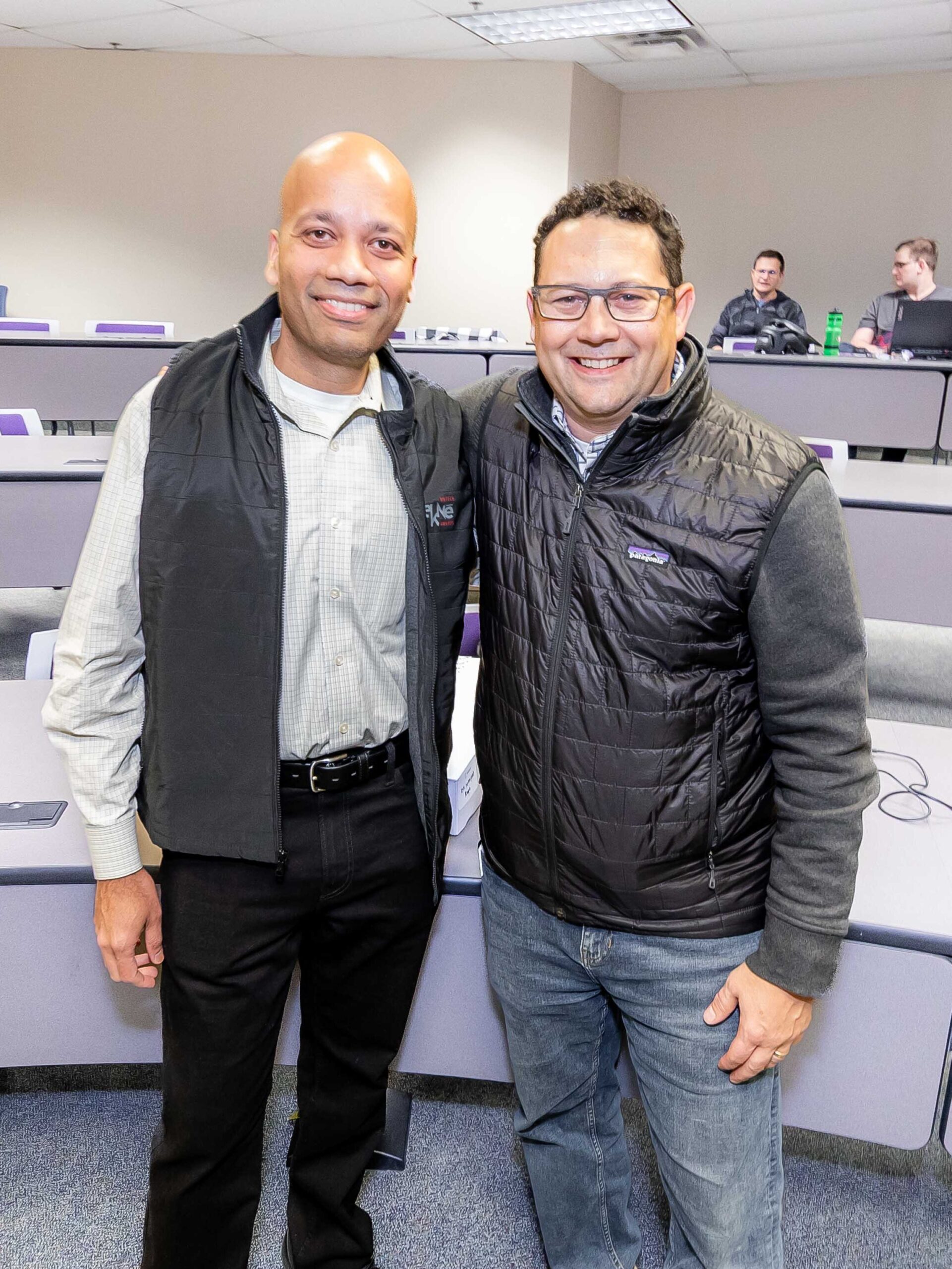 Manjeet Rege and Tony Peleska smiling for camera
